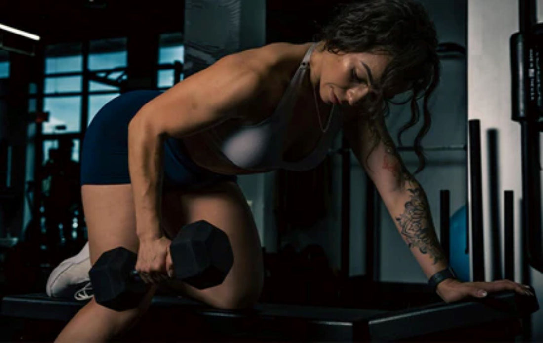 Individual executing a dumbbell row in a home gym for back muscle development.