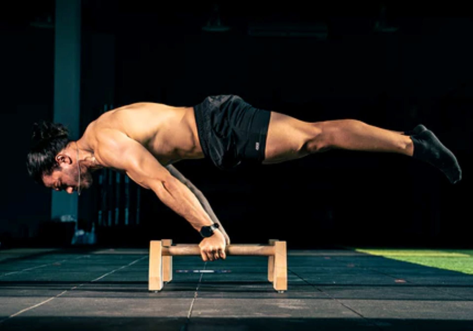 Man performing a planche exercise as part of advanced bodyweight training.