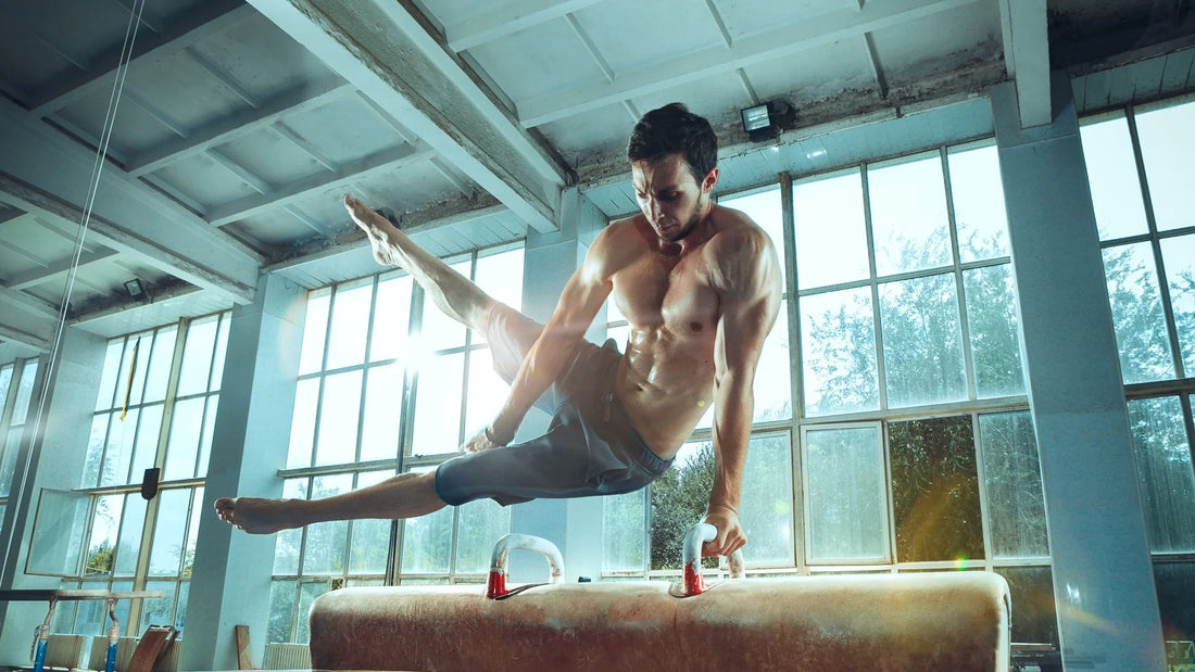 A male gymnast performing a high-level routine on pommel horse, showcasing advanced strength and control in a home gym setup.