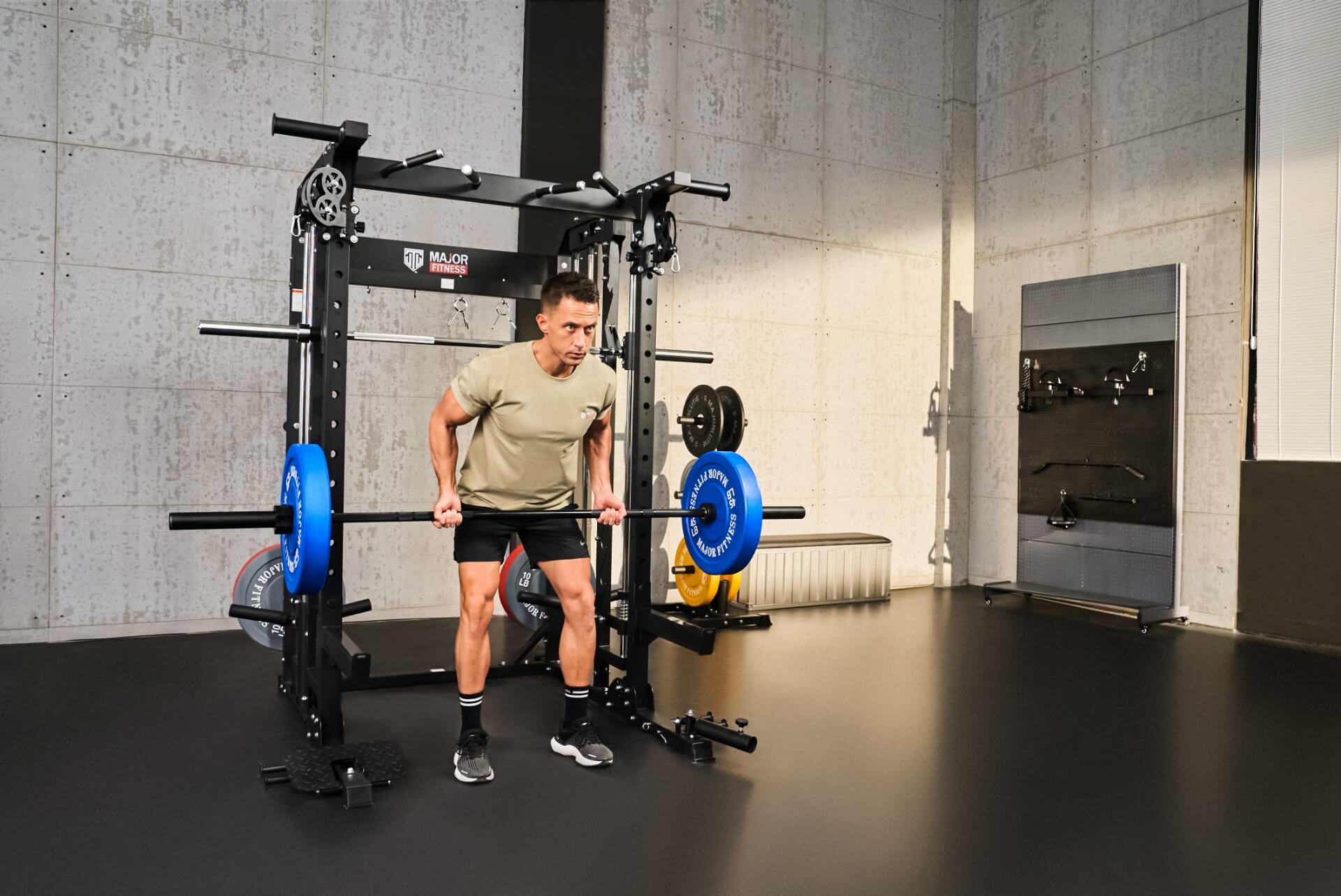 Man practicing barbell curls as part of his strength training routine in a home gym.