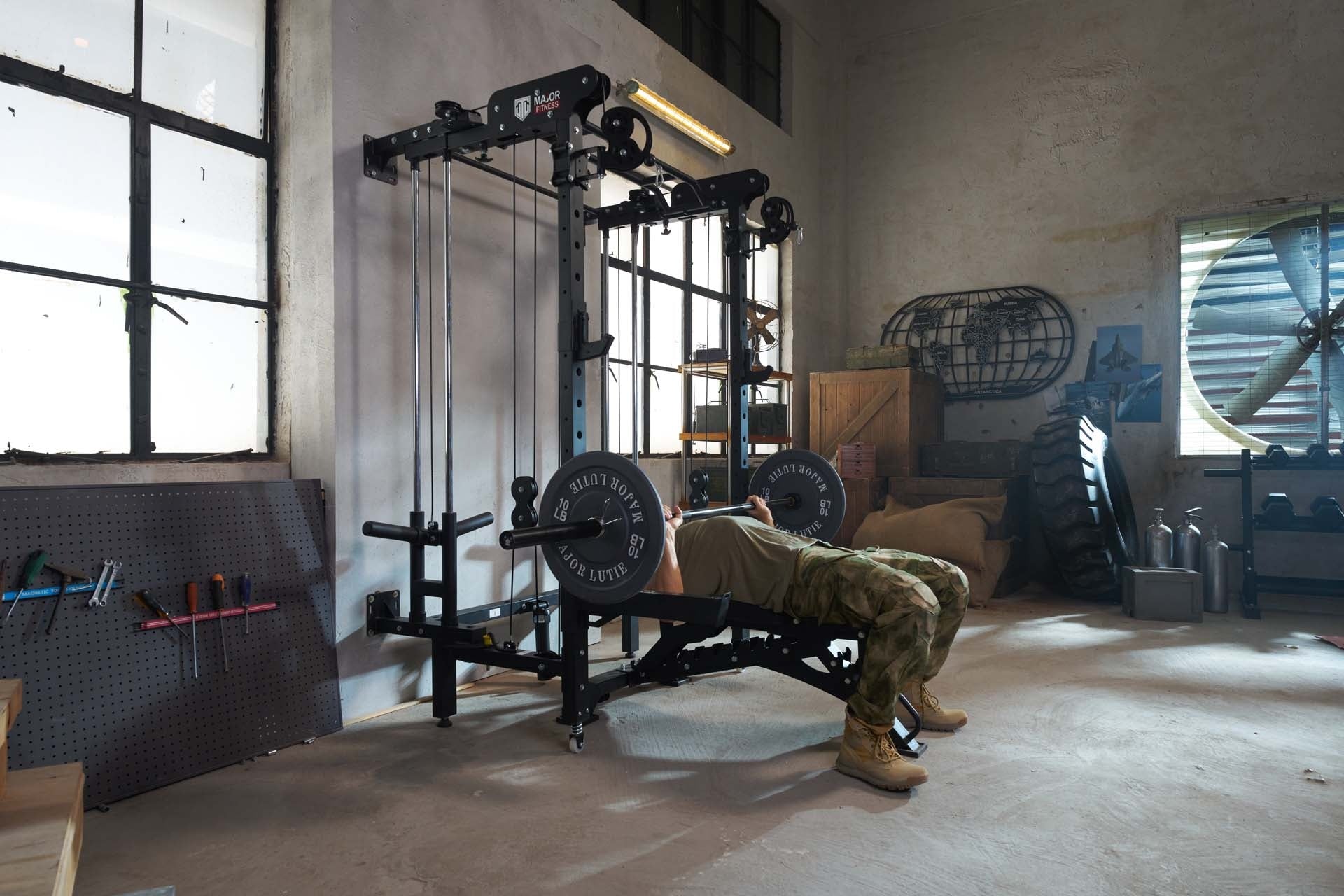 Individual performing incline bench press workout with a Smith machine in a home gym.