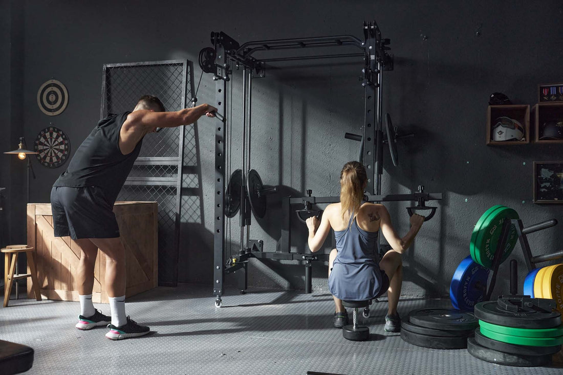 A man and a woman performing strength training exercises using a Smith machine in a home gym.