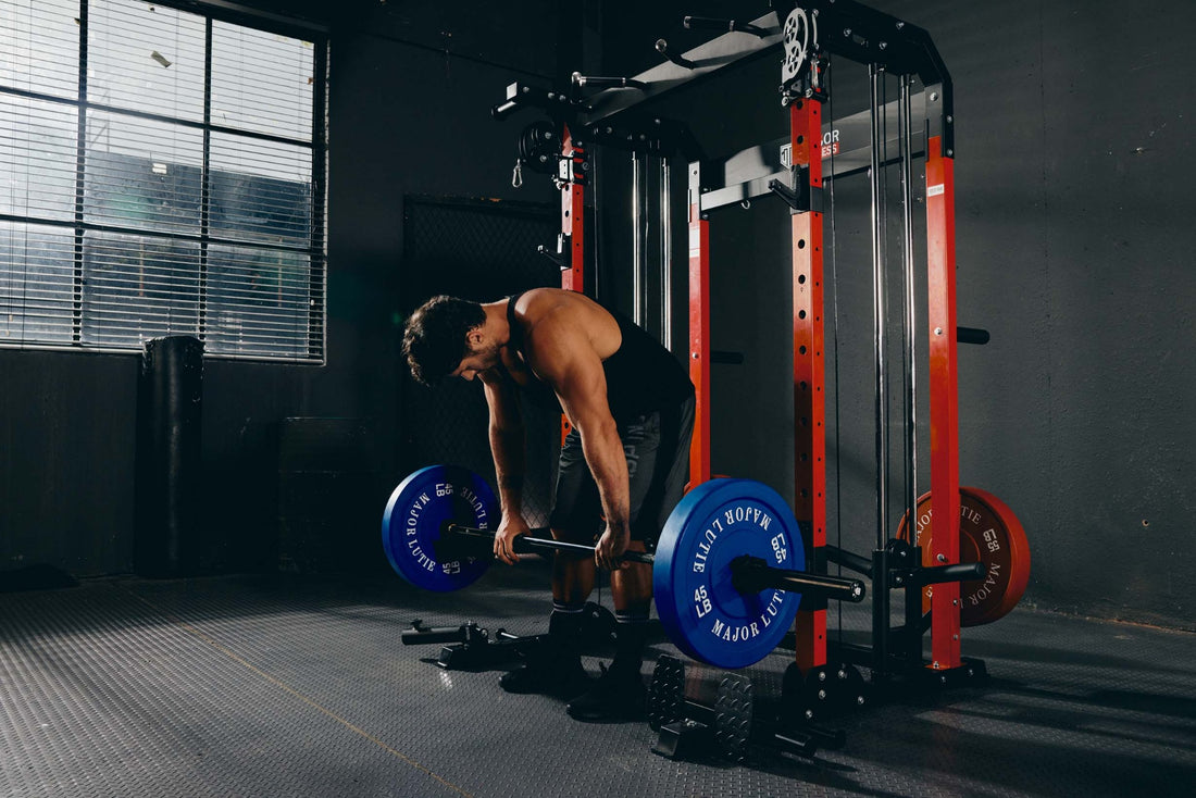 Athlete executing a deadlift exercise using a barbell in a home gym setup.