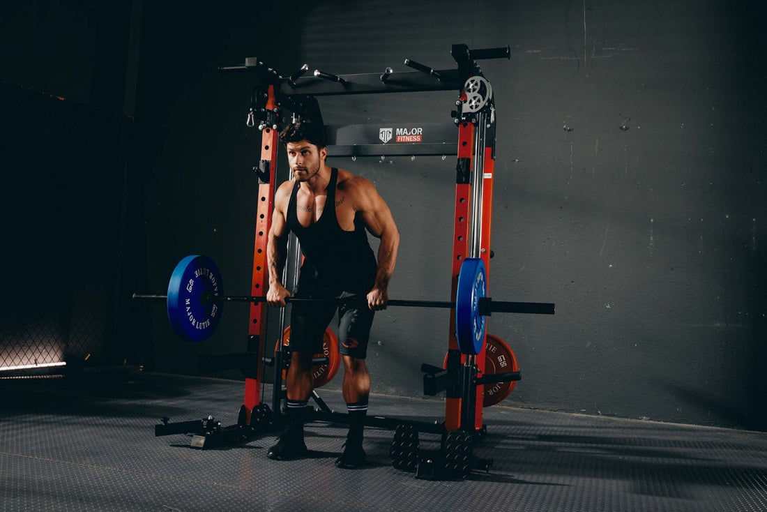 Man executing a deadlift as part of his workout routine in a fitness room with a power rack.