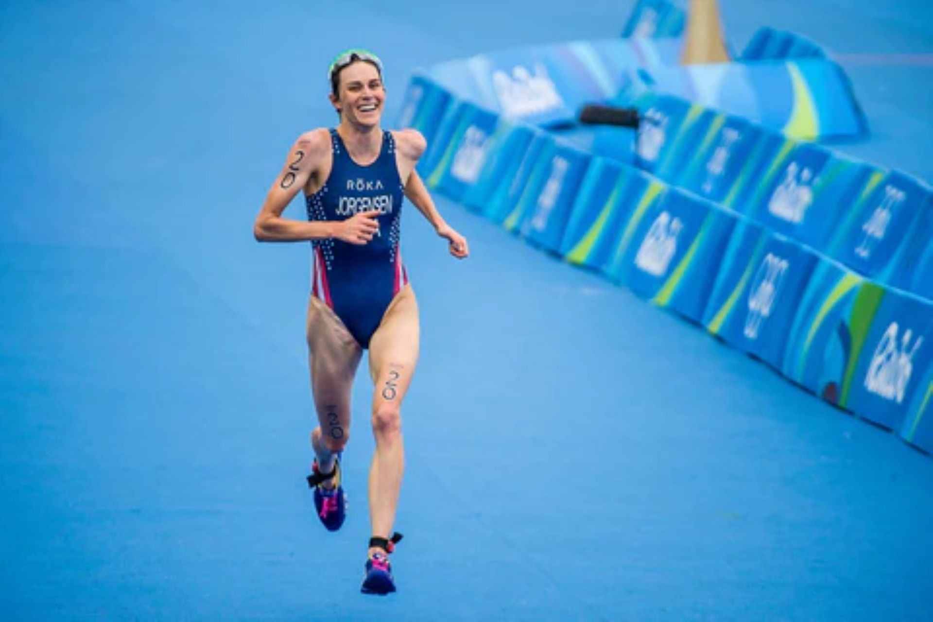 Female triathlete running in a race during a triathlon event.