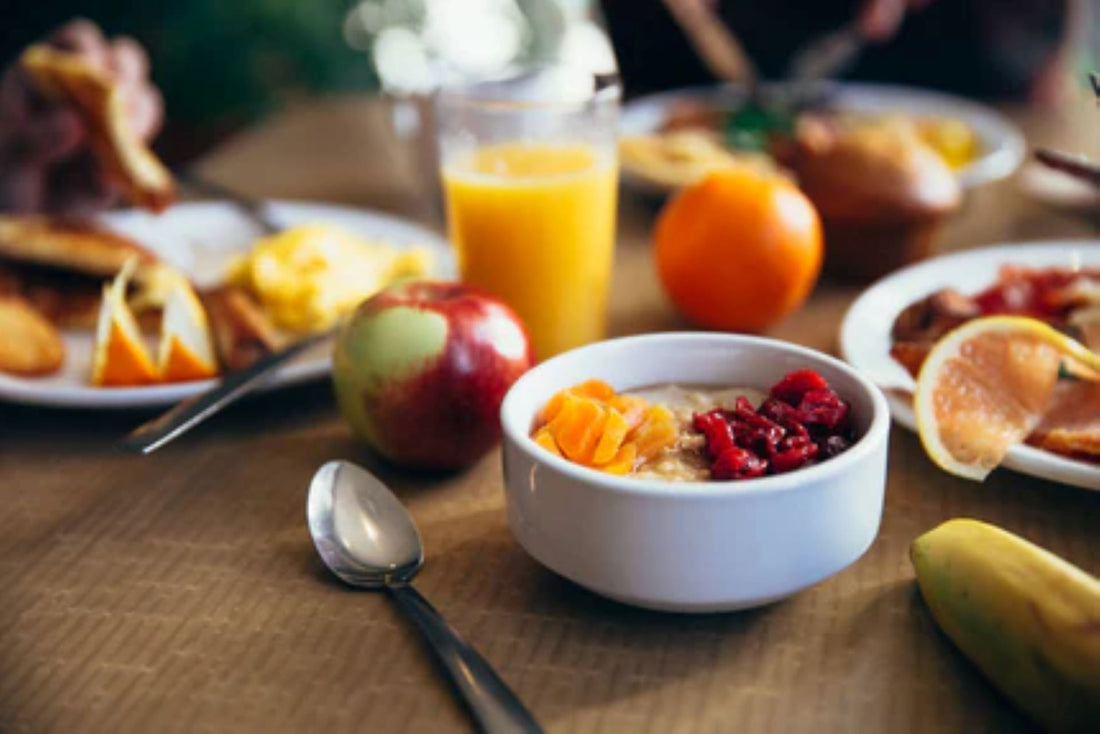 A healthy and balanced breakfast with fruits, oatmeal, and juice for fitness enthusiasts.