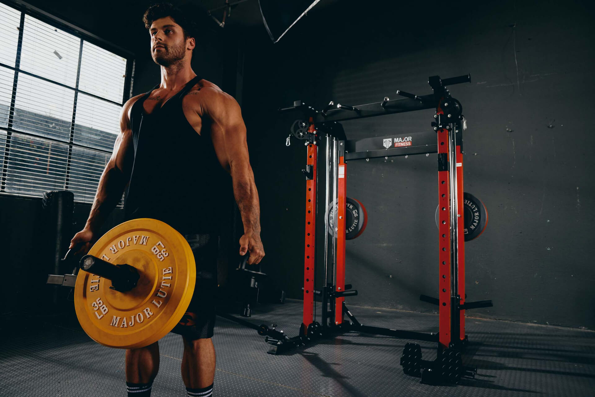 Home gym deadlift workout using weight plates and power rack.