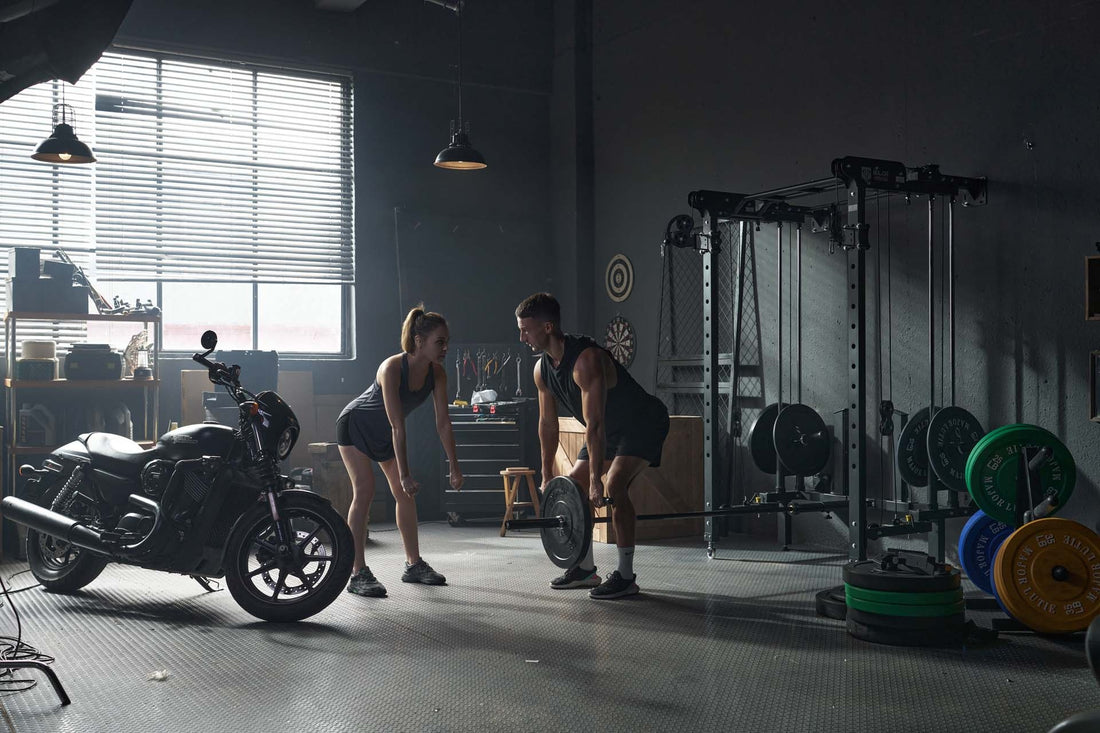 Man and woman performing exercises with a Smith machine and barbell in a home gym.