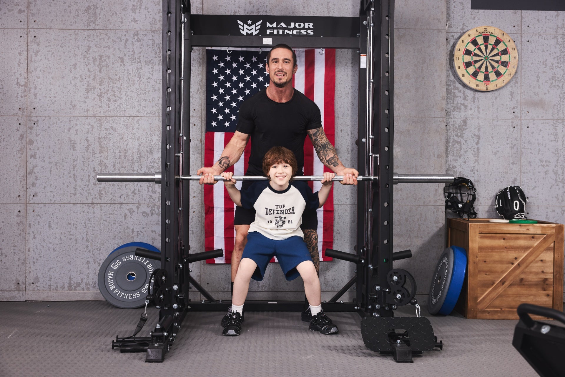 Family fitness training with a father and son using a Smith machine in a home gym.