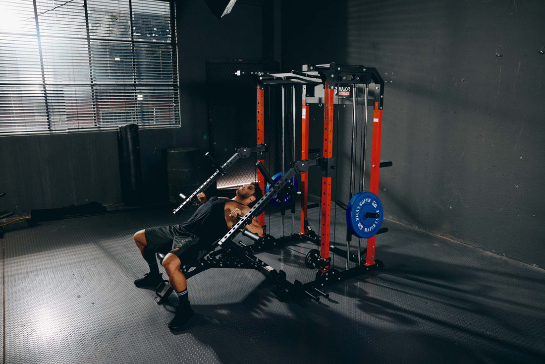 Individual doing an incline bench press workout with Major Lutie Smith machine in a fitness room.