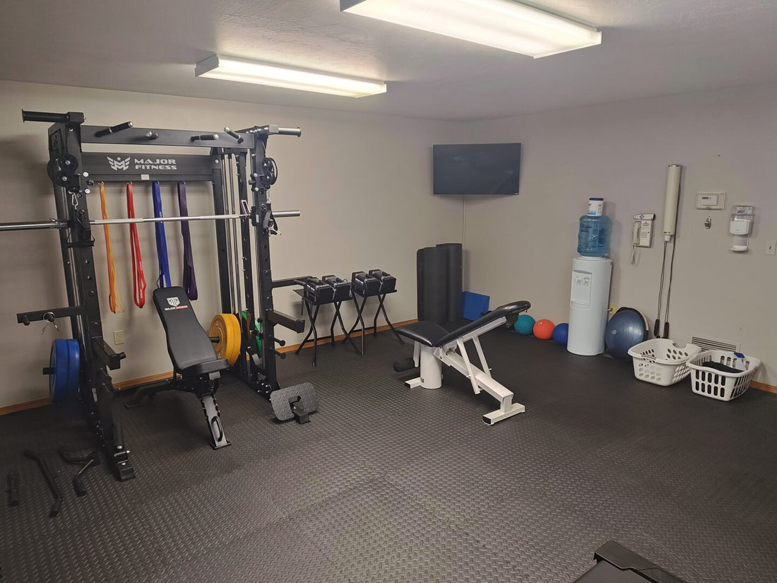 Compact home fitness room with weight bench, dumbbells, and exercise balls