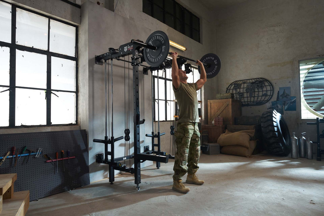 Individual doing a shoulder press with a Major Lutie Smith machine in a fitness room.