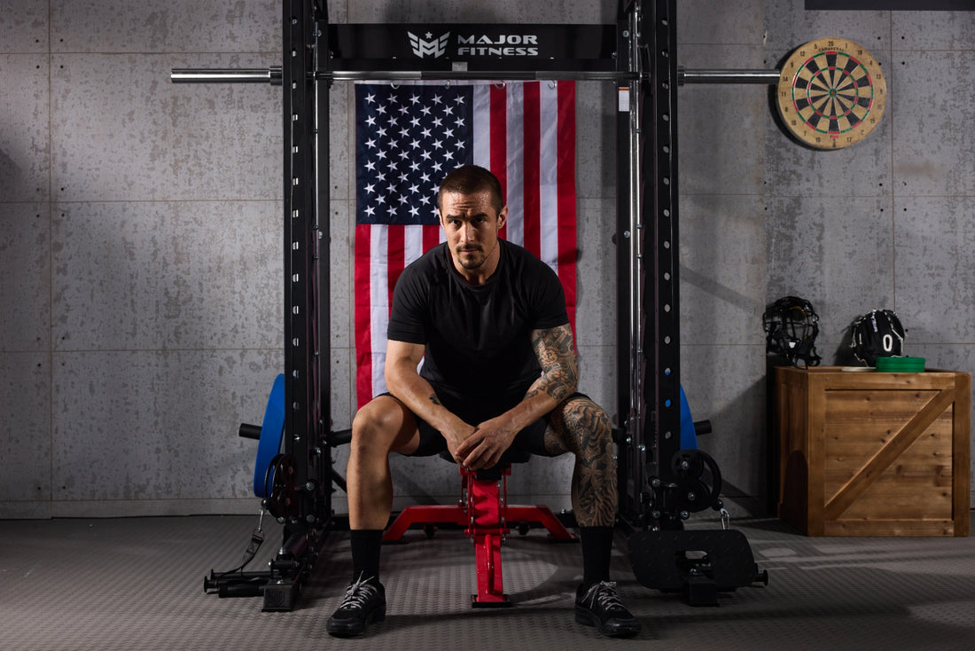 Man taking a break on a bench in front of a Smith machine