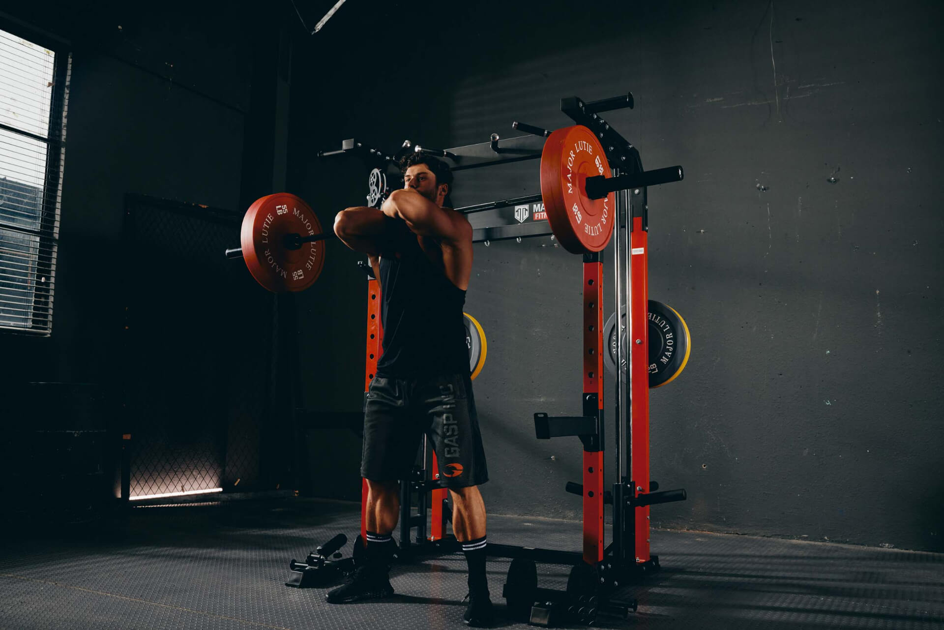 Man doing a squat workout with a Smith machine.