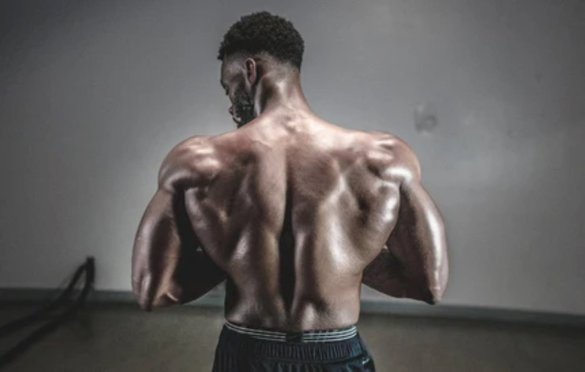  A male athlete showing defined back muscles and strength.