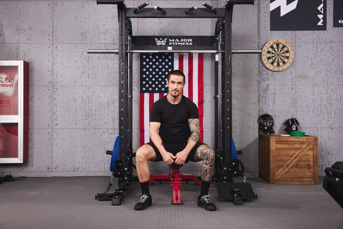 Individual resting in home gym with smith machine setup.