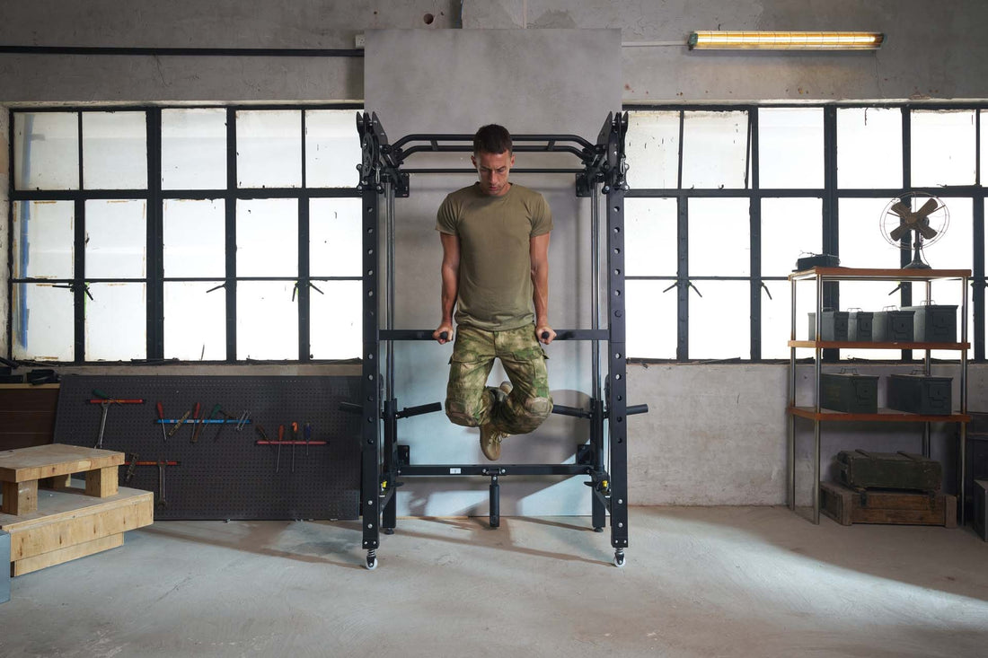 Man engaged in strength training with dips on a power rack in a home gym.