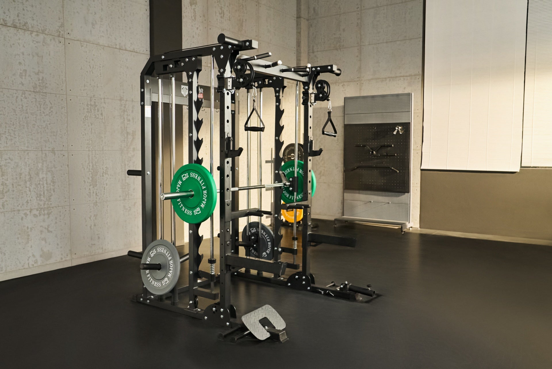 Multifunctional Smith machine with green and blue weight plates and an adjustable bench.