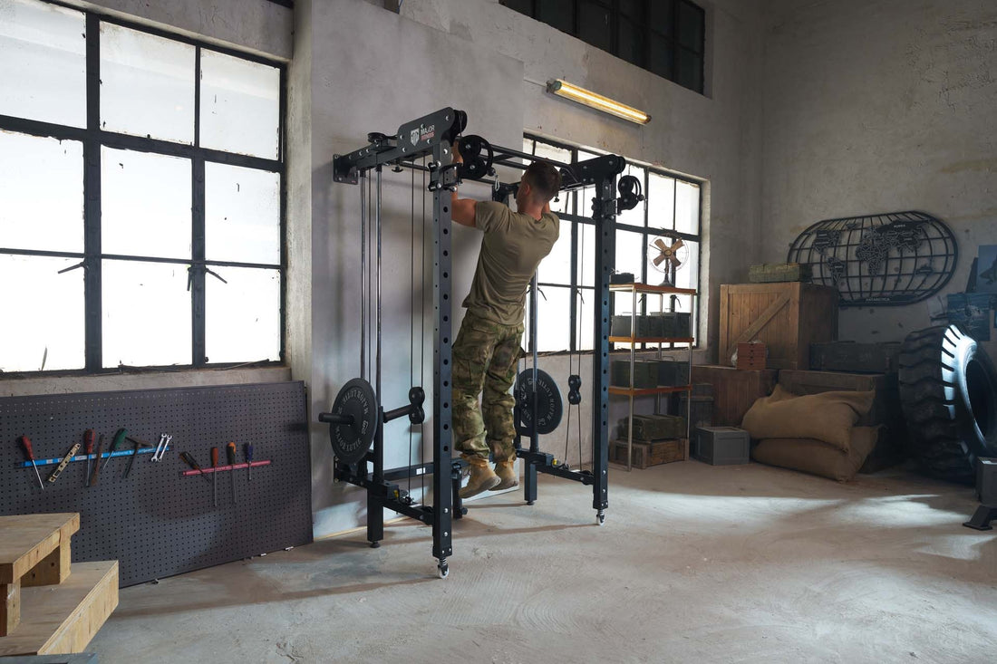  Individual doing a pull-up on a power rack in a garage gym.