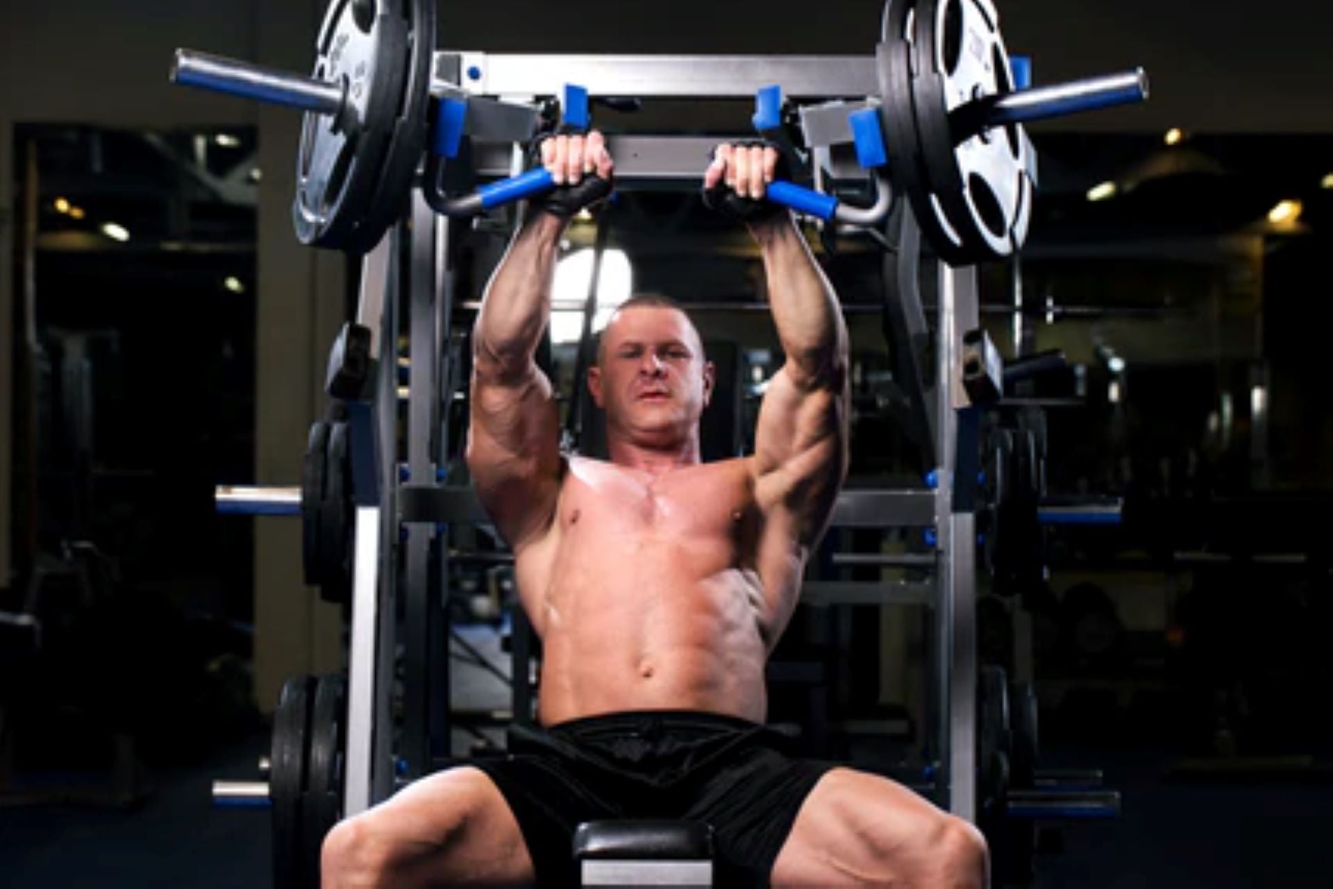 man performing seated bench press on a Smith machine for chest strength.