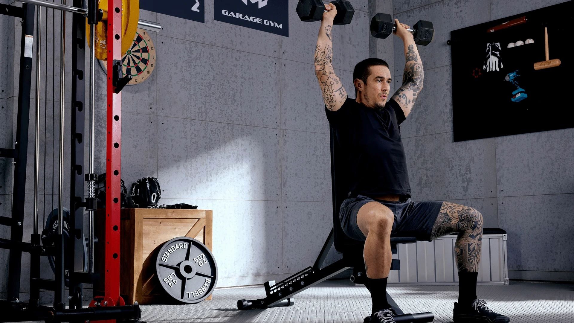 Fitness enthusiast executing a dumbbell shoulder press, emphasizing effective upper body workout techniques in a home gym environment.