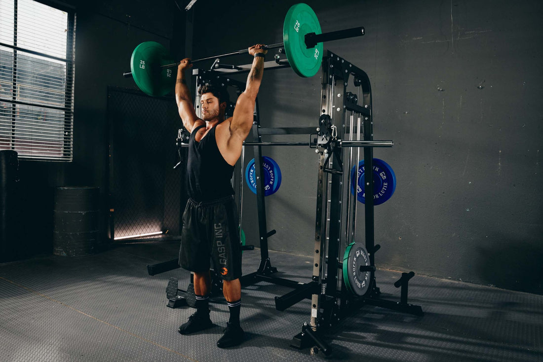 Home gym setup featuring a man doing shoulder exercises on a Smith machine.