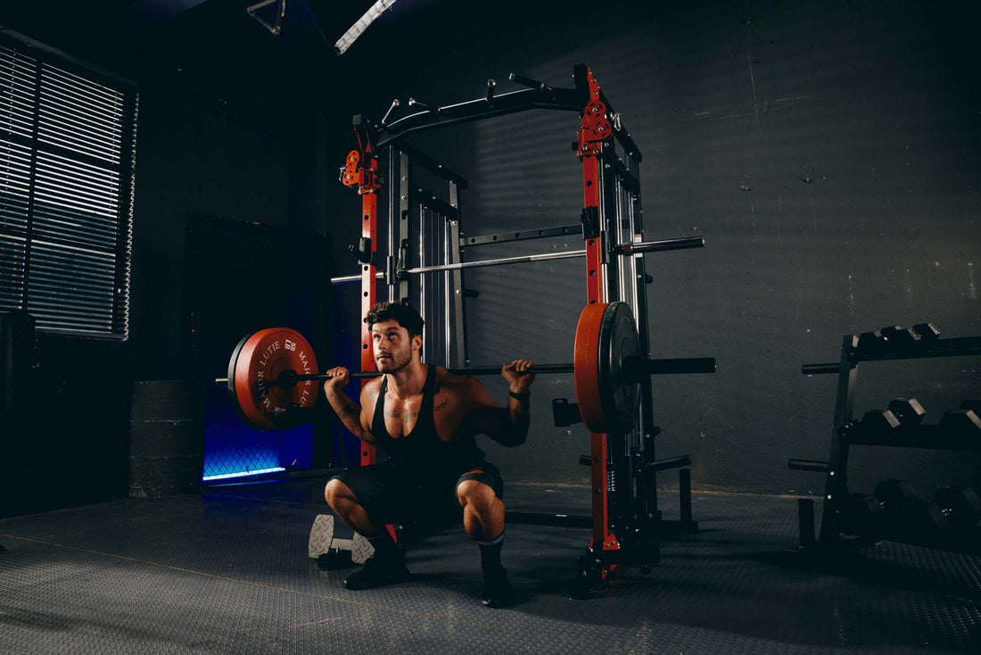 Man performing back squats with Smith machine in home gym.