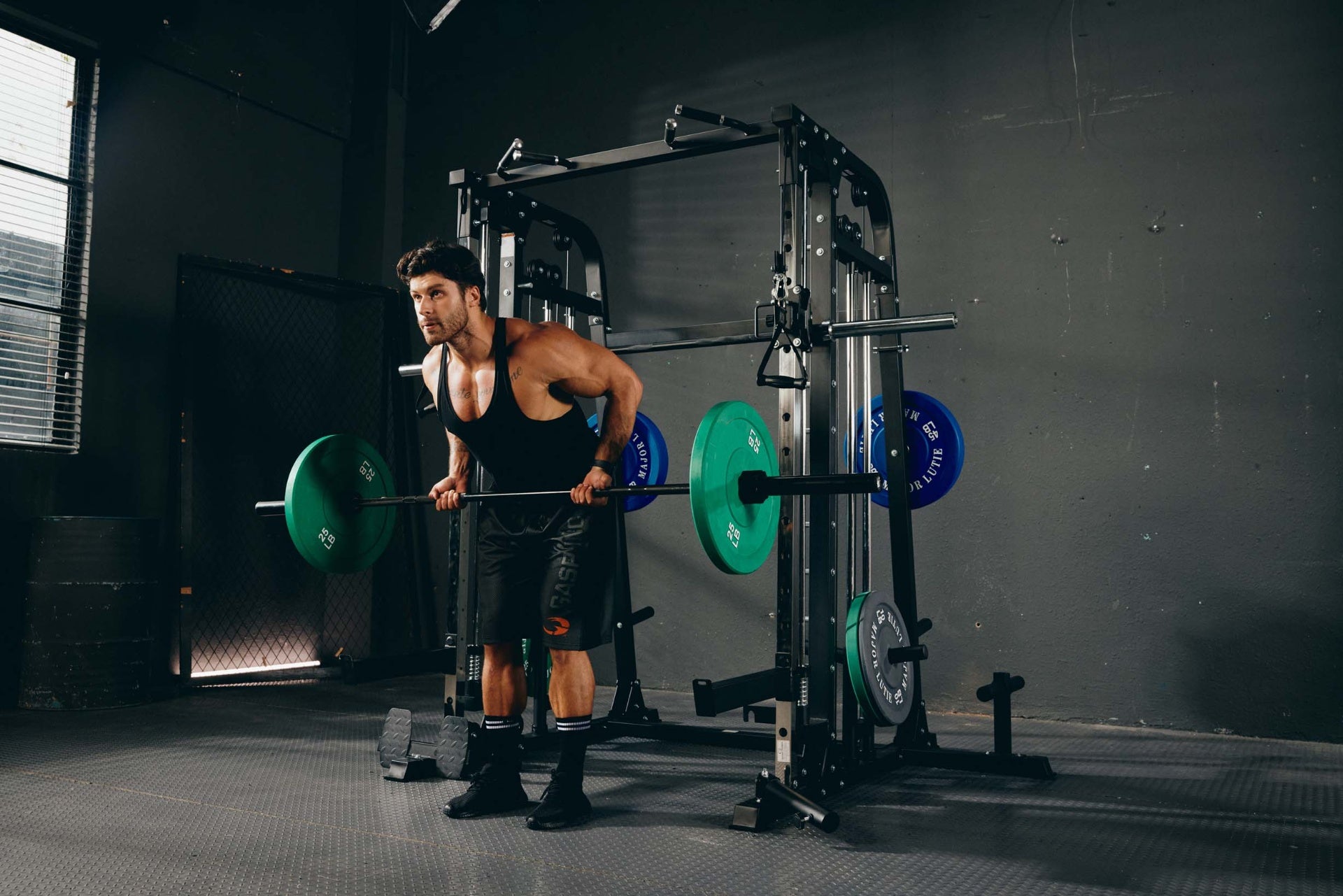 Strength training barbell row exercise with a Smith machine.