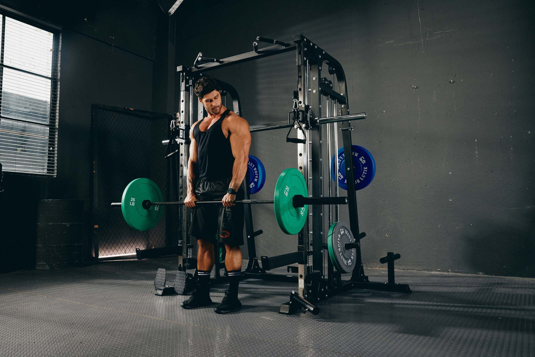 Man performing a deadlift exercise using a Smith machine in a gym.