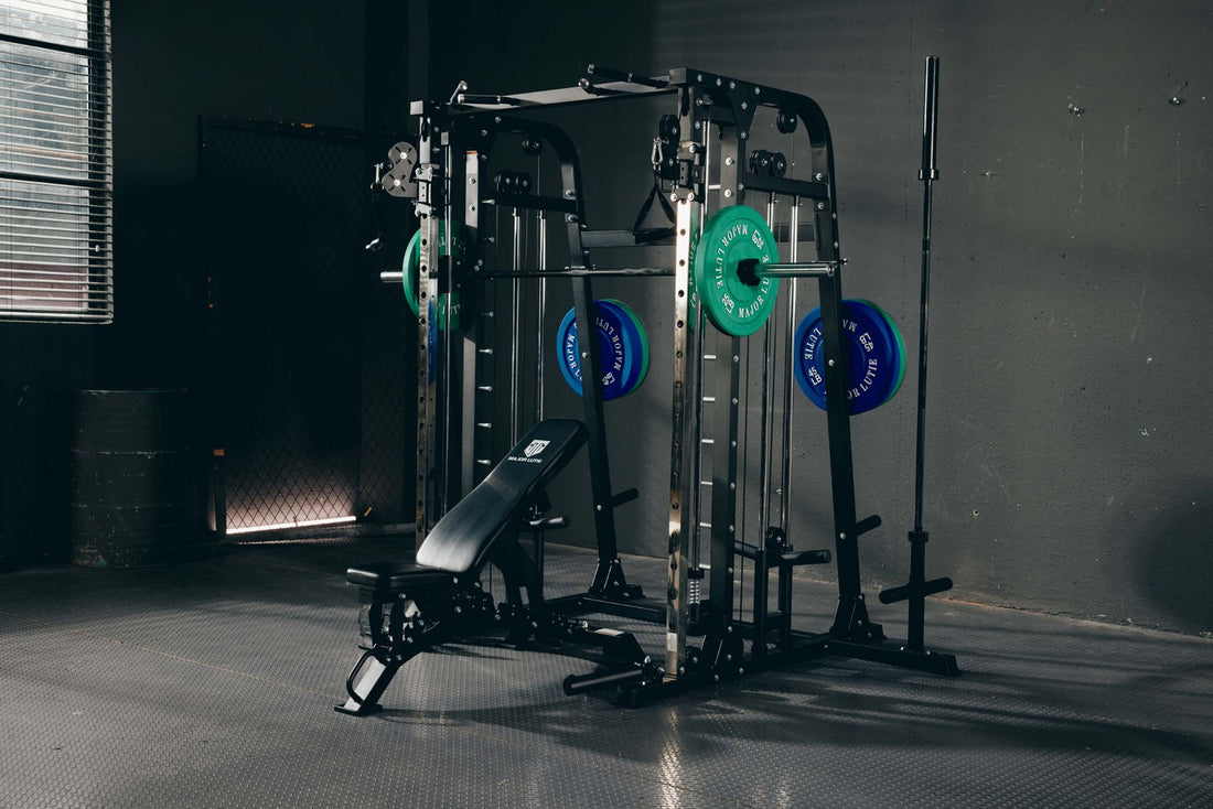 Multifunctional Smith machine with green and blue weight plates and an adjustable bench.