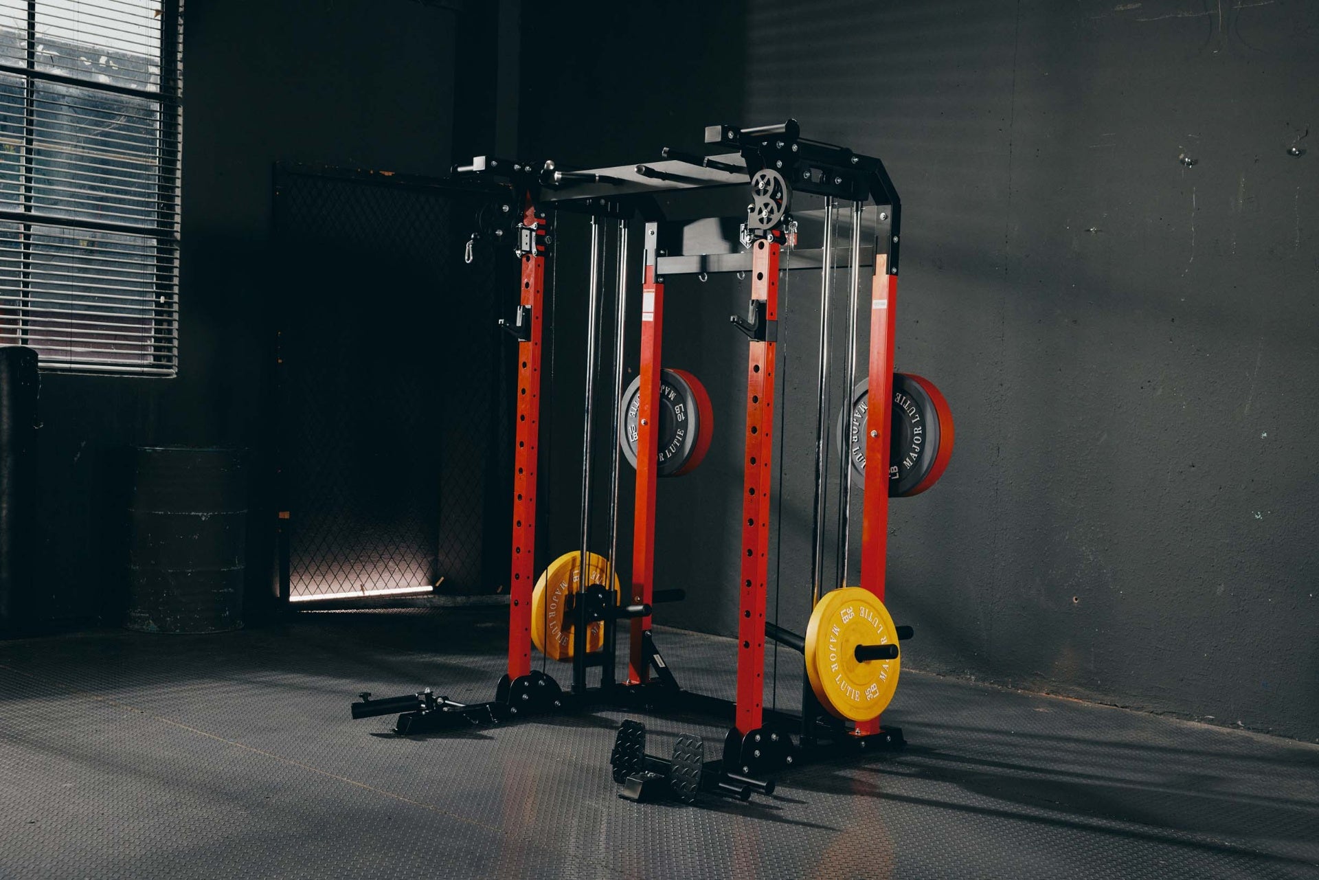 Home gym Smith machine featuring red and yellow weight plates.