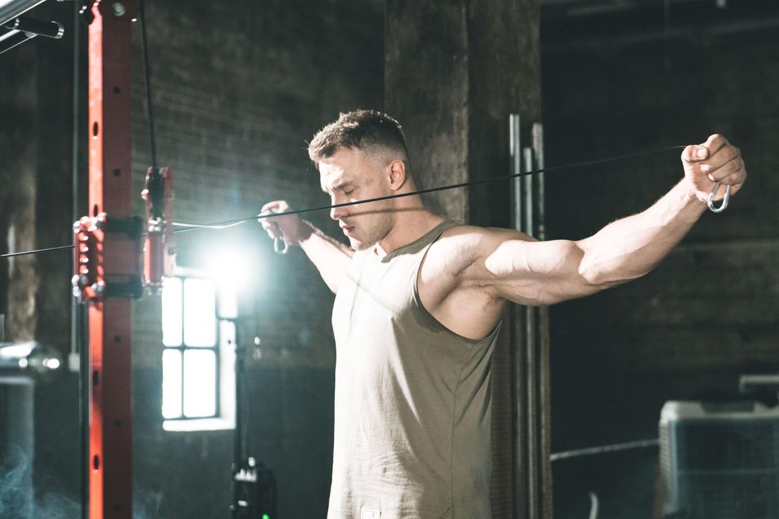 Individual performing chest fly workout with a resistance band in a home gym.