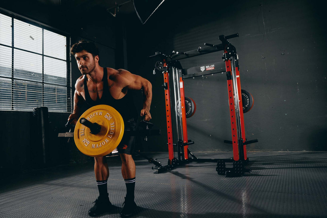  A man performing a deadlift with weight plates in a home gym, focusing on strength training and muscle building.