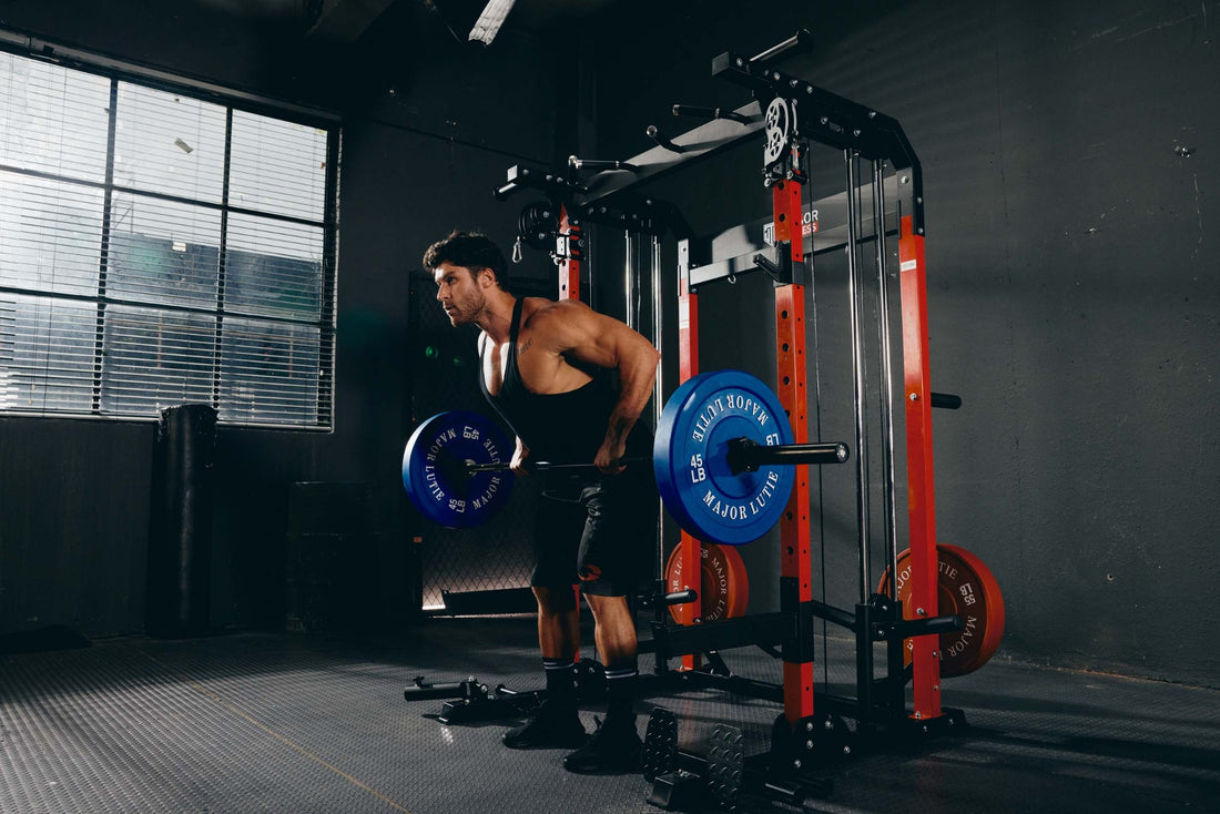 Athlete executing a barbell row exercise using a Smith machine in a home gym setup.