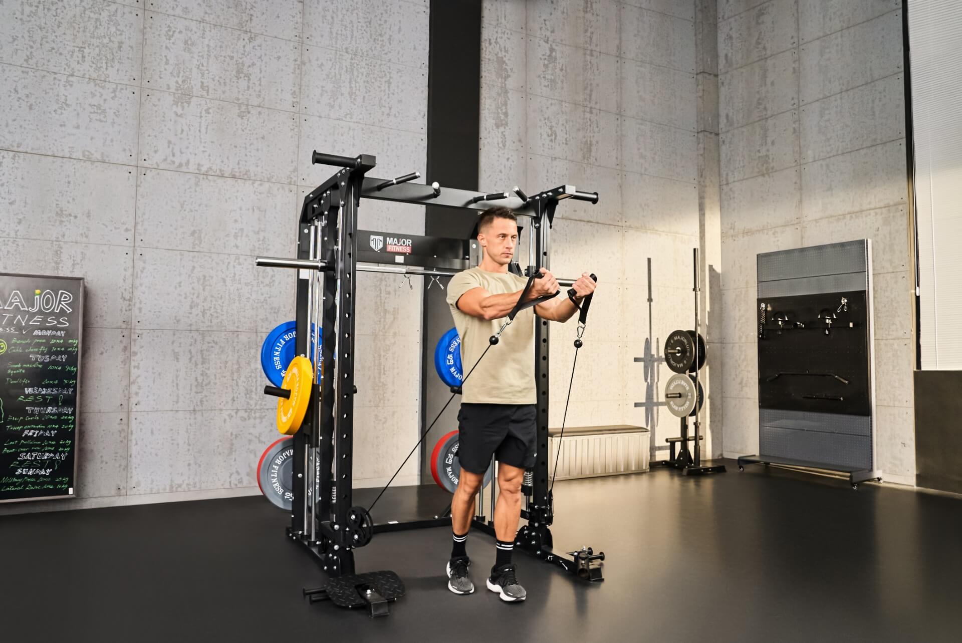 Man using cable attachments for a workout on a Smith machine in a gym