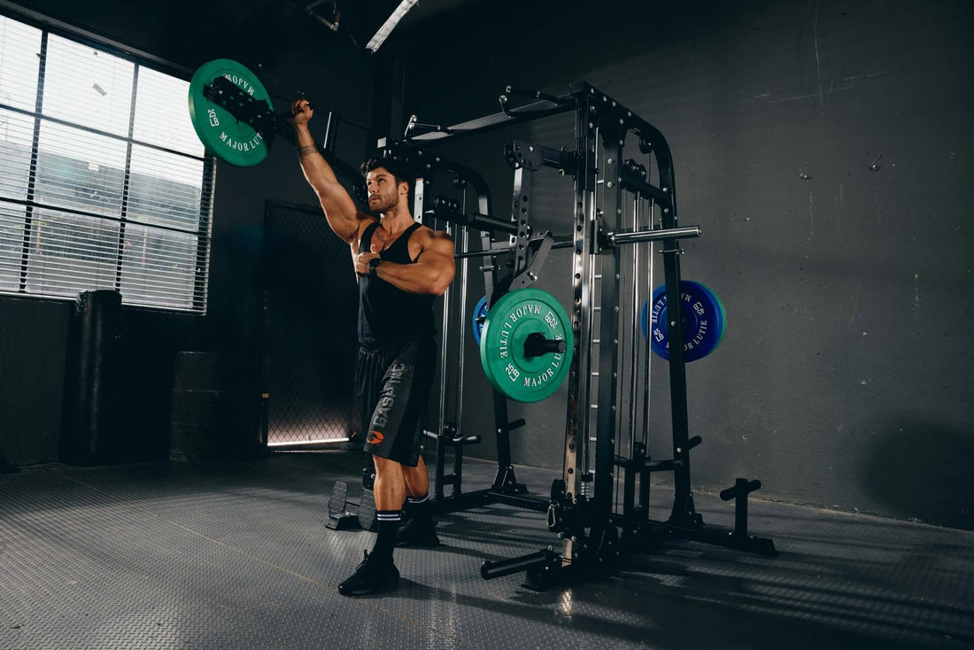 Male athlete executing an overhead press exercise in a home gym setup.