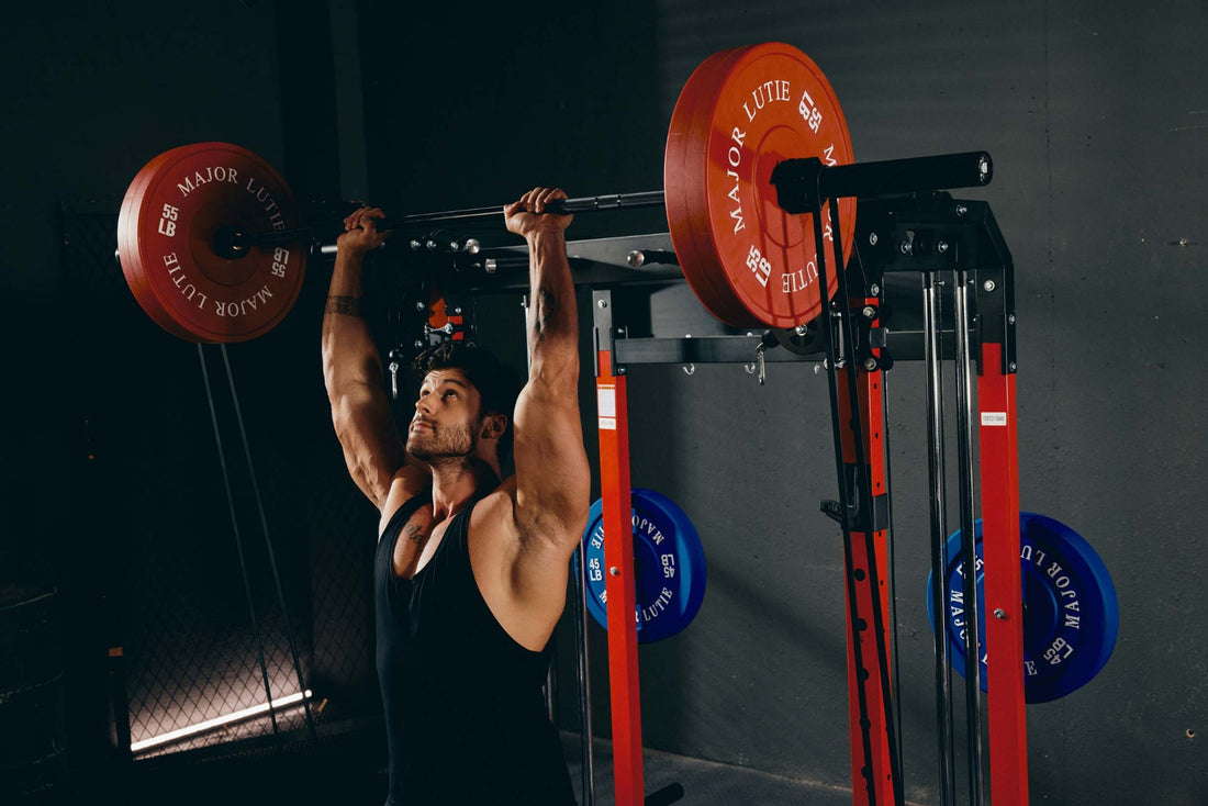 Strength workout with an overhead press on a power rack, highlighting home gym equipment.