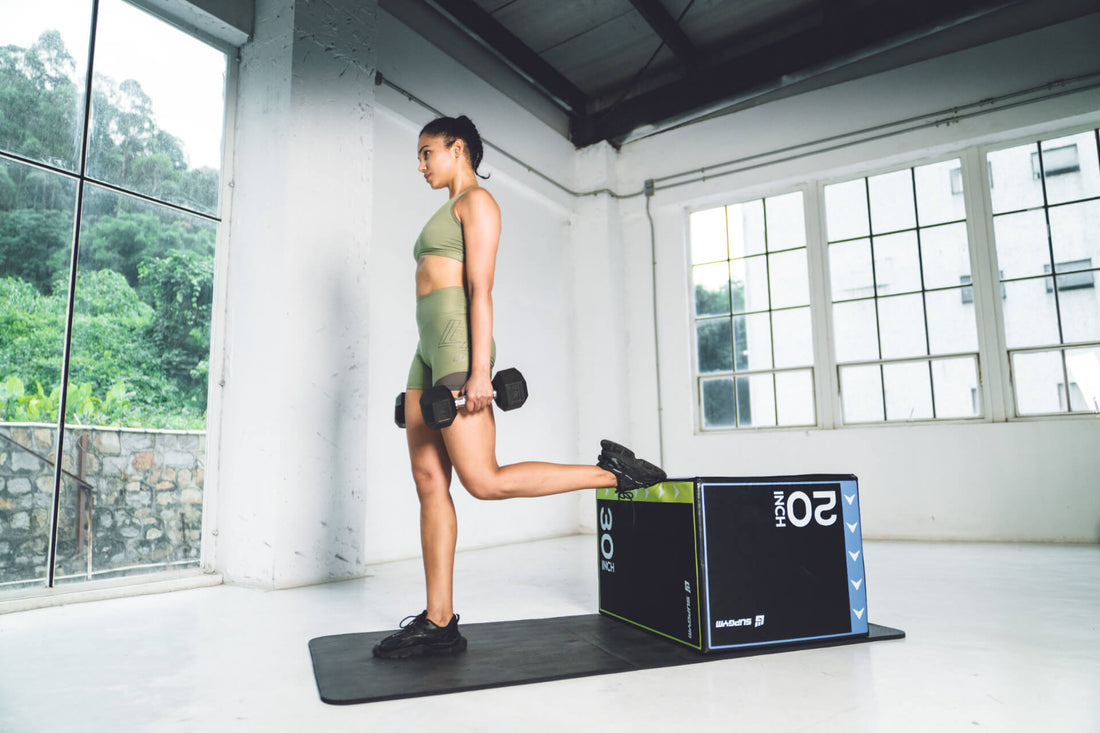 woman executing a strength training Bulgarian split squat with dumbbells in a home gym environment