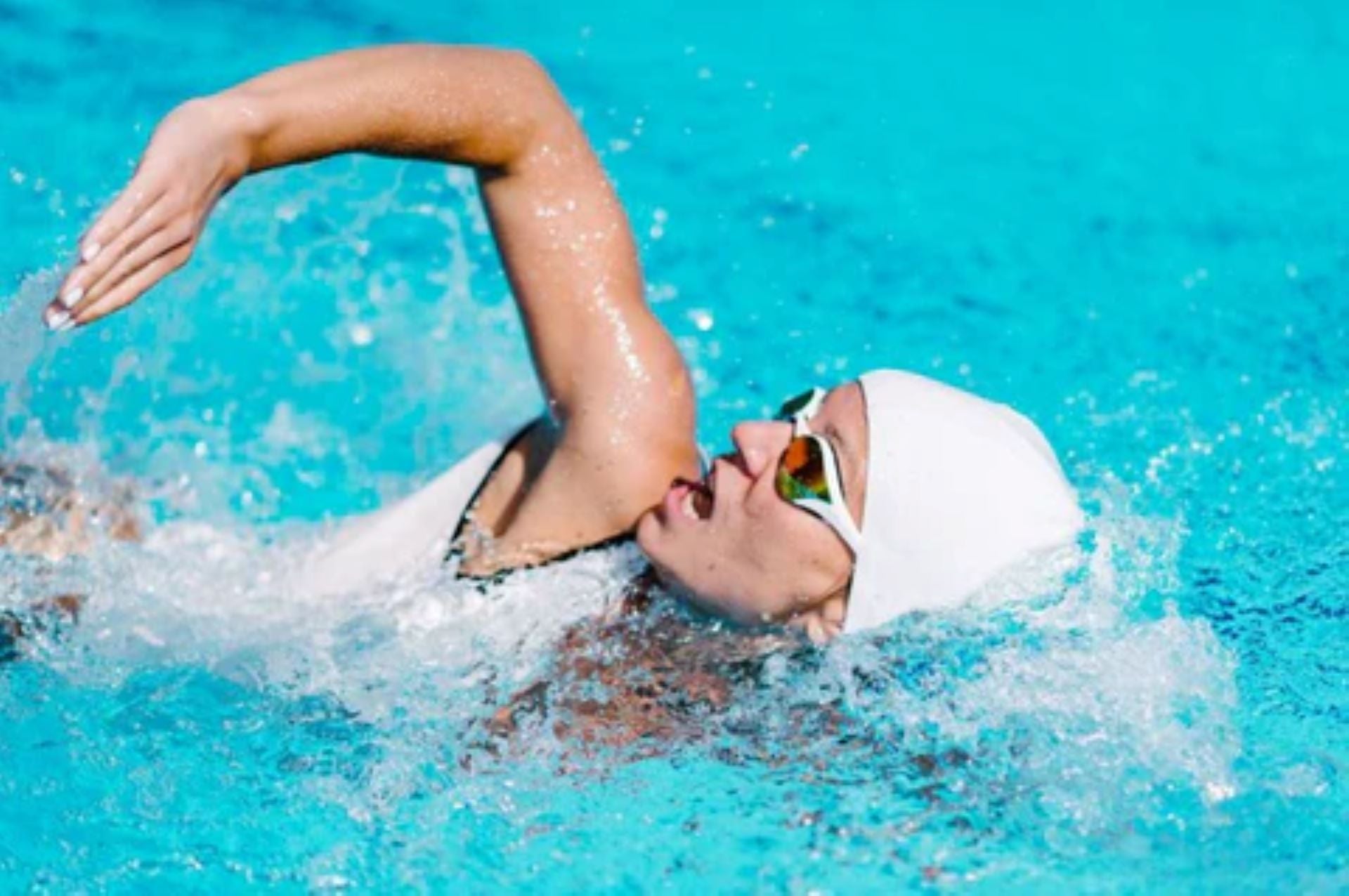  Athlete demonstrating backstroke technique in a swimming pool, focused on competitive performance and endurance.