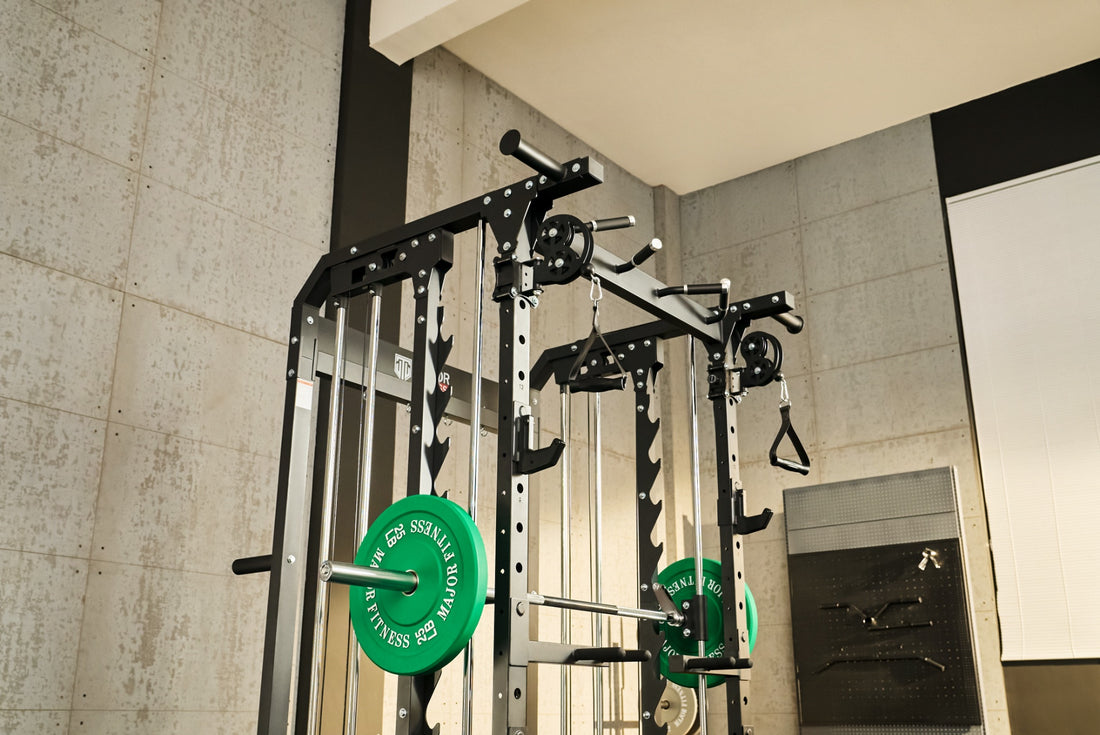 Upper section of a Smith machine in a home gym featuring green weight plates.