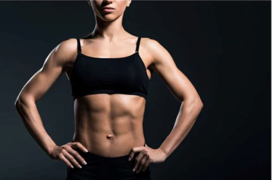 Woman's fit and muscular abs, highlighting core strength and fitness.