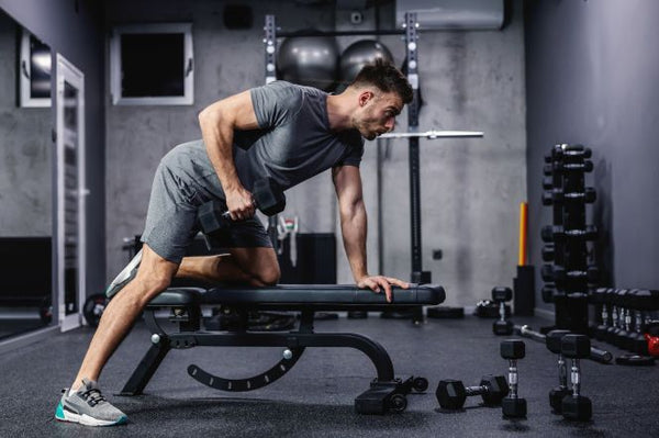 Home workout featuring a man lifting dumbbells