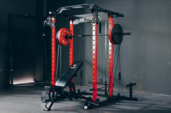 Major Fitness power rack setup in a home gym with an adjustable weight bench, loaded with weights and featuring cable pulleys.
